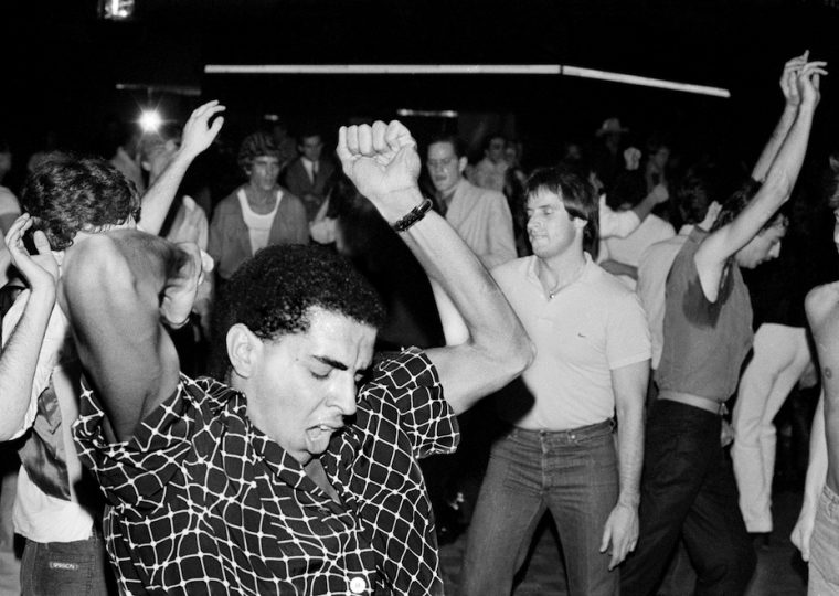 Black and white photo of people dancing in club