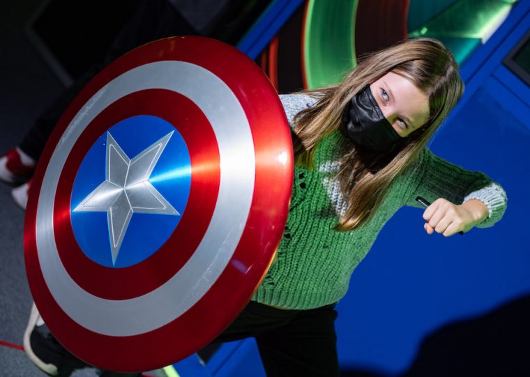 girl holding Captain America shield