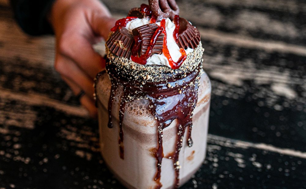 Person holding a hot chocolate