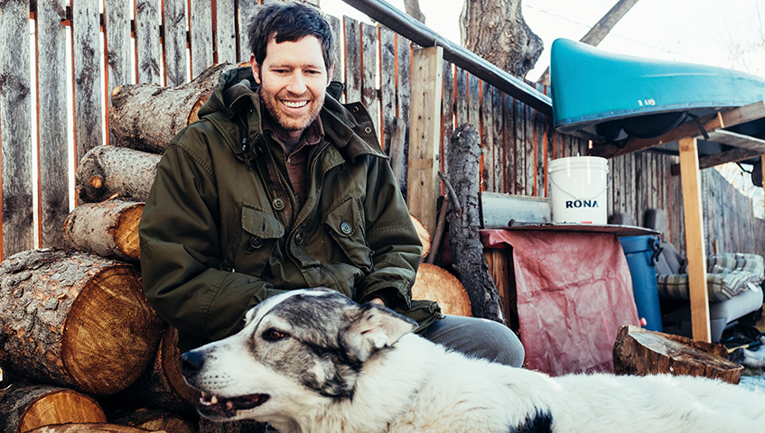 Chad VanGaalen sitting outside with dog