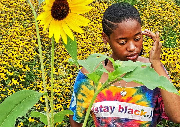 Person in sunflower field