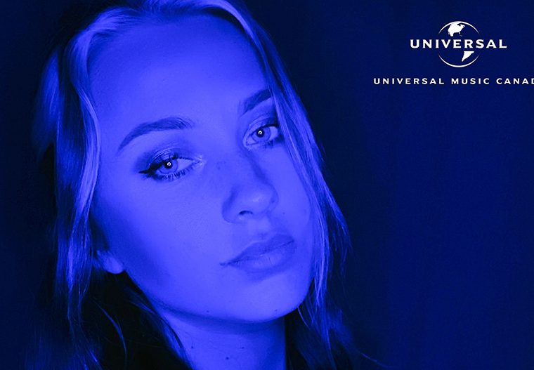 Kutcher posing with Universal Logo in top right