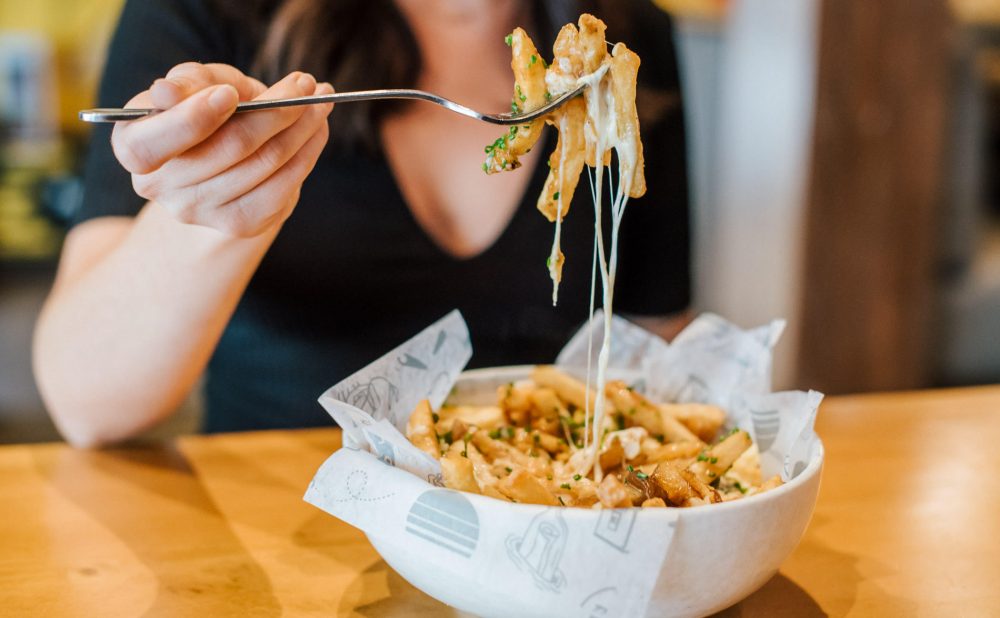 woman eating poutine