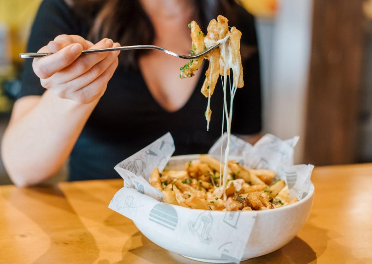 woman eating poutine