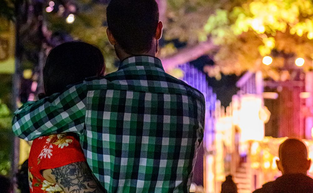 Couple watching theatre in park
