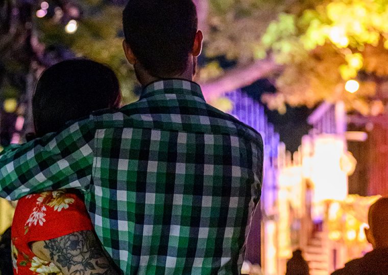 Couple watching theatre in park