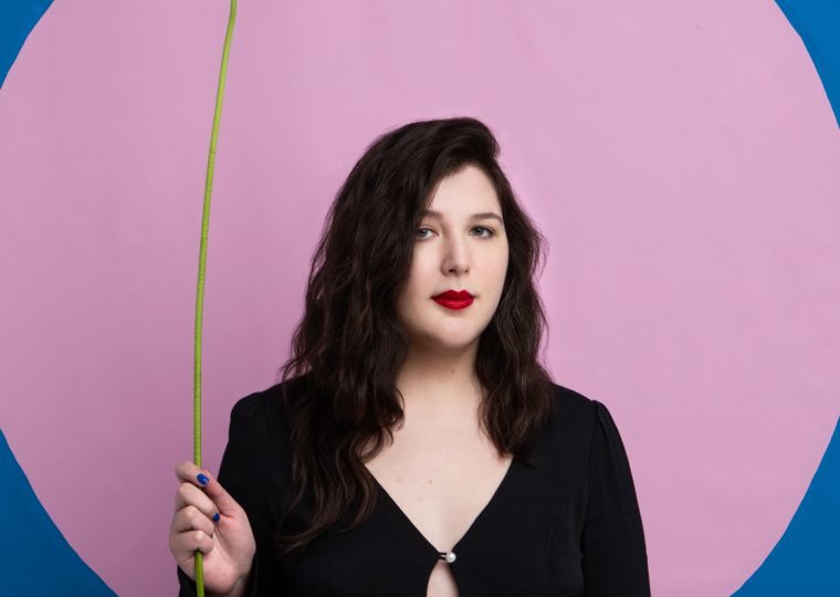 Lucy Ducas posing with flower