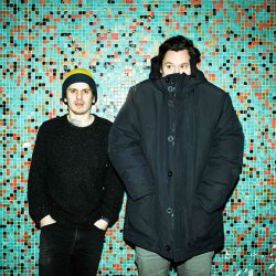 The Front Bottoms posing against subway tile