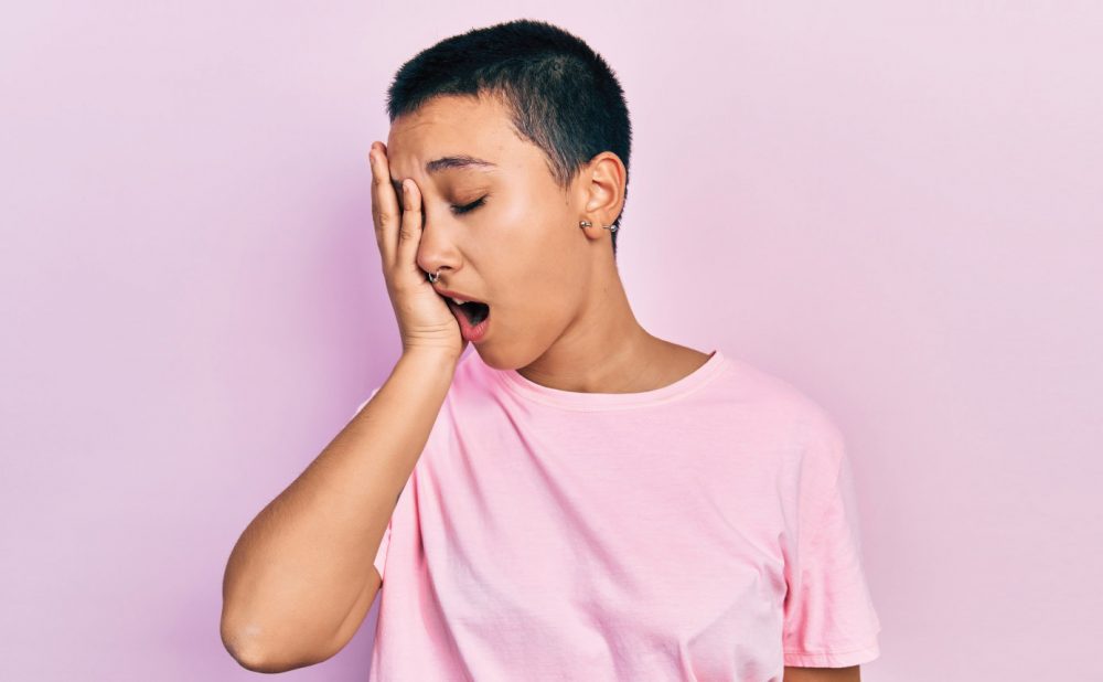 Person wearing pink yawning