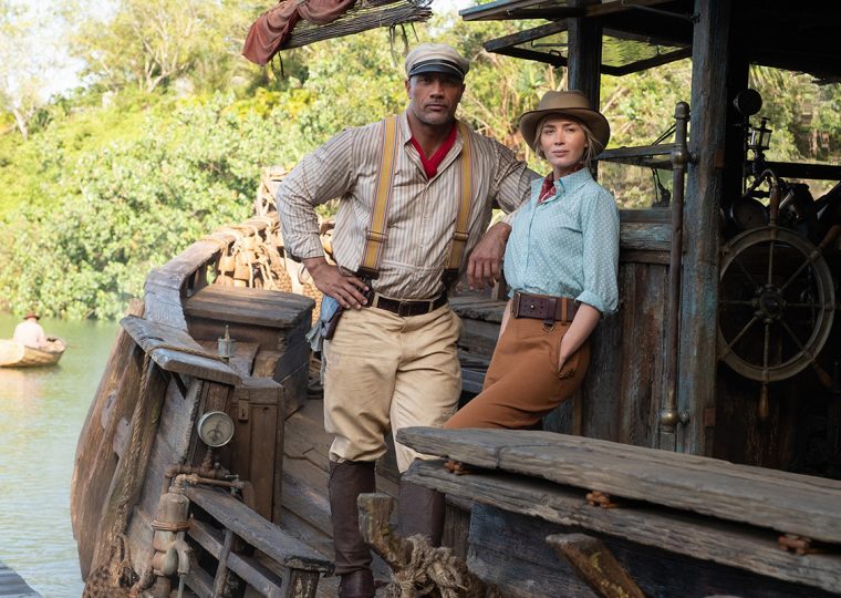 Dwayne Johnson and Emily Blunt posing on a boat for the Jungle Cruise movie.