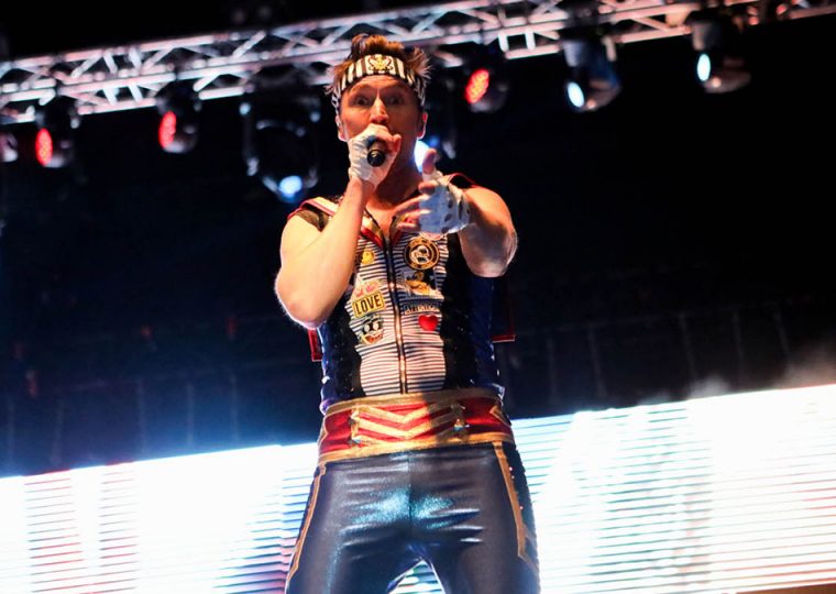 A member of the band Aqua performing on stage.