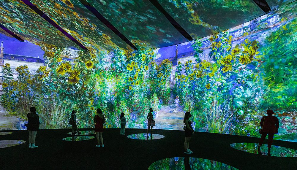 Attendees enjoying the immersive Monet exhibit.