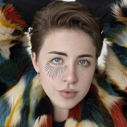 Close-up of Russell Louder's face, with lines drawn between the right eye, like elongated eyelashes.