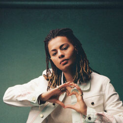 Lala &ce making a heart outline with her hands.