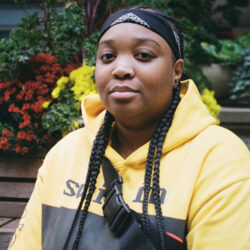 DijahSB in a red and black colour-blocked hoodie