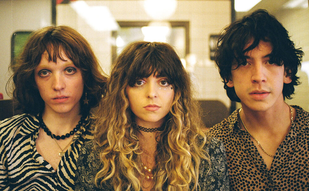 The Velveteers facing the camera side by side.