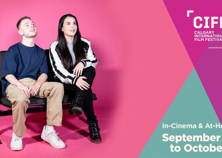 A man and woman sitting on a bench against a pink backdrop, promoting the Calgary International Film Festival.