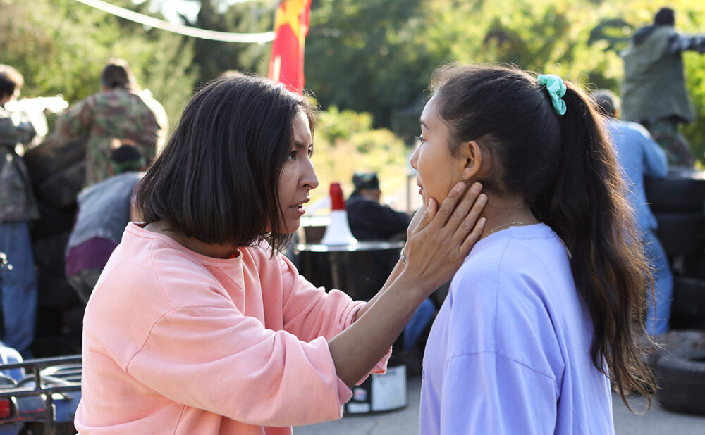 Still from the film Beans of a woman holding the face of a girl as they look at each other
