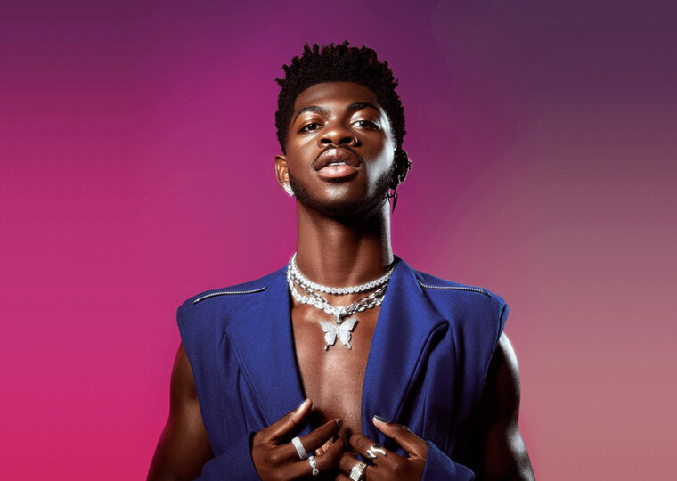 Lil Nas X posing against a pink gradient backdrop