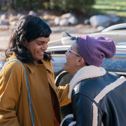 Scene from TV show Sort Of, two women facing each other, smiling at each other.