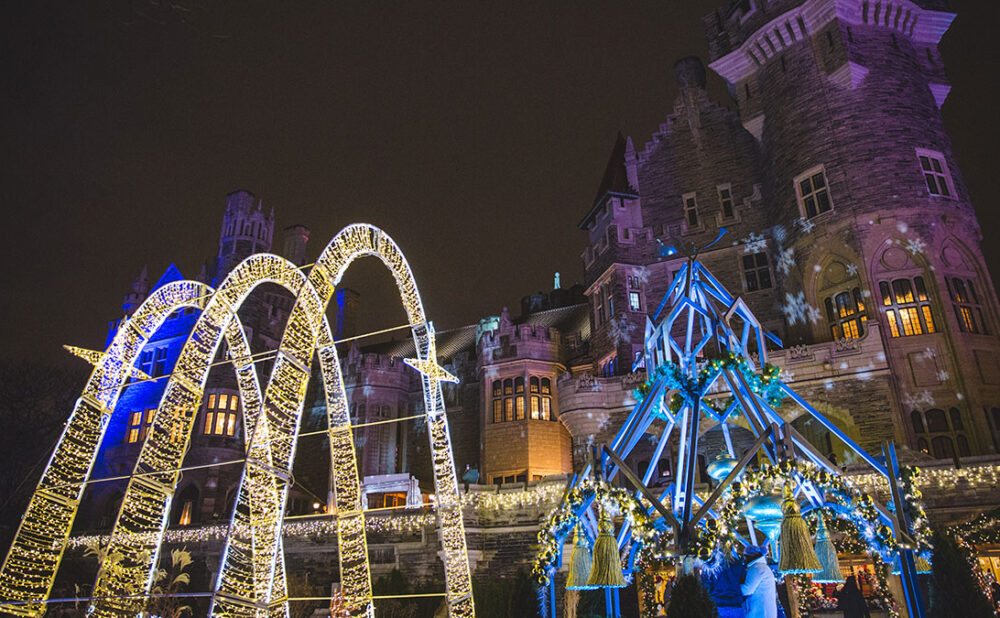 Casa Loma turned winter wonderland at night with colourful lights.