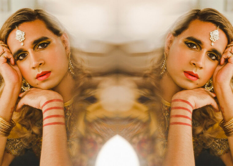 Vivek Shraya headshot, resting head on the back of the hand looking at the camera.