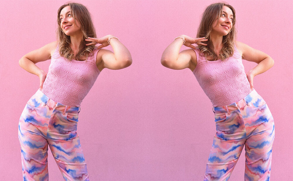Mirrored image of Devon Cole posing against a pink backdrop.
