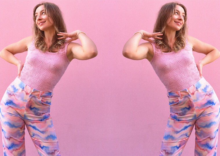 Mirrored image of Devon Cole posing against a pink backdrop.